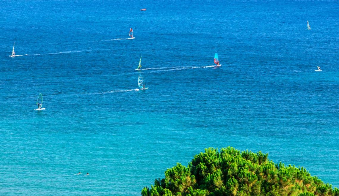 Windsurfers sailing across the Vasiliki Beach in Lefkada Island Greece