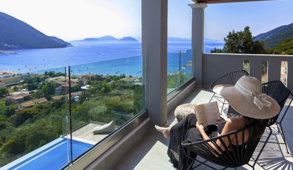 Villa Irene in vasiliki lefkada, girl reading on the private balcony and admiring the panoramic sea-mountain view
