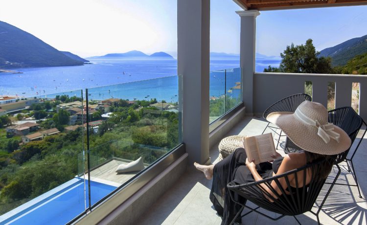 Villa Irene in vasiliki lefkada, girl reading on the private balcony and admiring the panoramic sea-mountain view