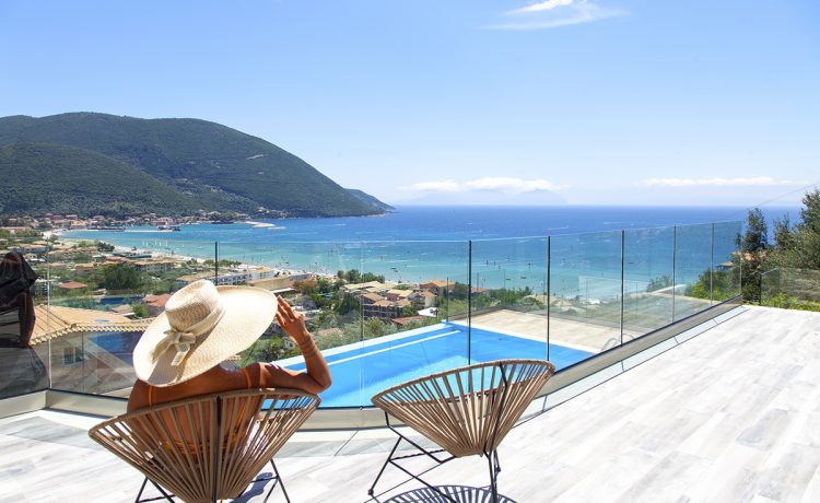 Villa Irene in vasiliki lefkada greece, girl seating outdoors and admiring the panoramic view