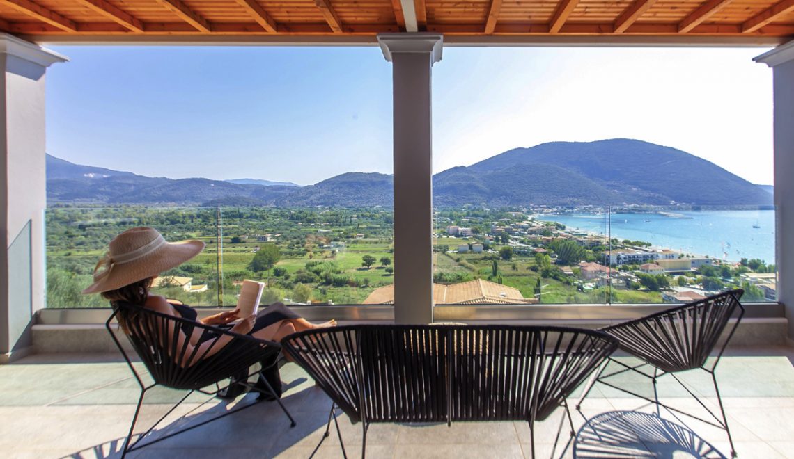 Villa irene in vasiliki lefkada, a girl overlooking the sea view from the private balcony