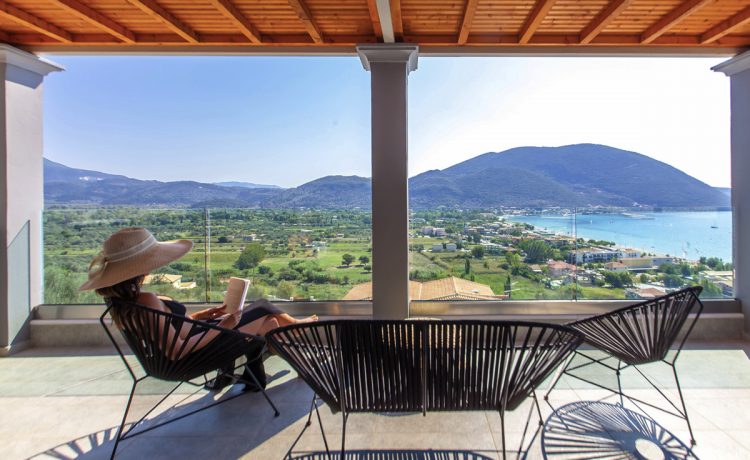 Villa irene in vasiliki lefkada, a girl overlooking the sea view from the private balcony